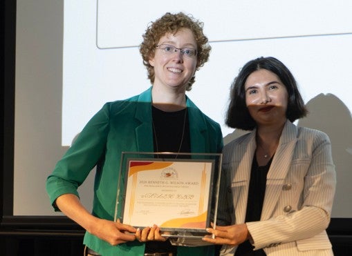Zohreh Davoudi (right) handing the 2026 Wilson Award to Natalie Klco (left).