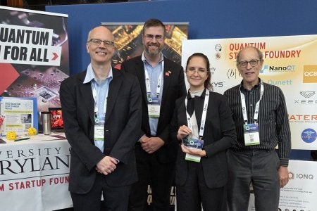 Maria Yuffa together with the proposers of the challenge Wolfgang Losert, John Sawyer, and Franz Klein at the QLab/QSF booth.
