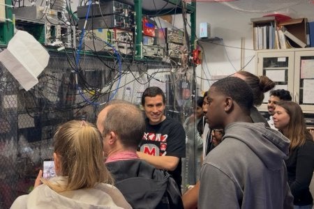 Norbert Linke explaining an ion-trap quantum computer to vistors at Maryland Day.